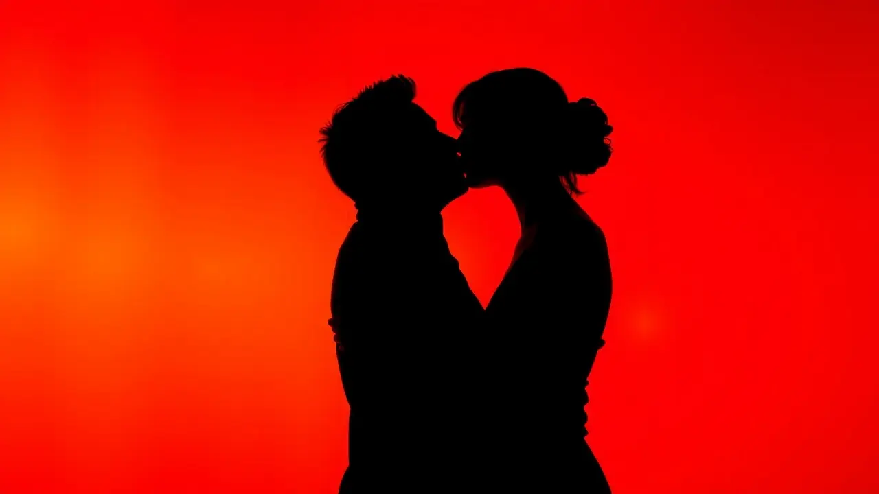 Orgasmic Licks Review: Unlock Your Partner’s Pleasure! Silhouettes kissing against a red background, representing passion and intimacy.